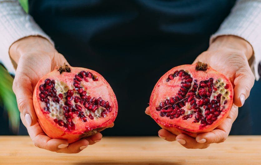Fresh Pomegranate Fruit Gardenfrontier A freshly halved pomegranate revealing bright red juicy seeds