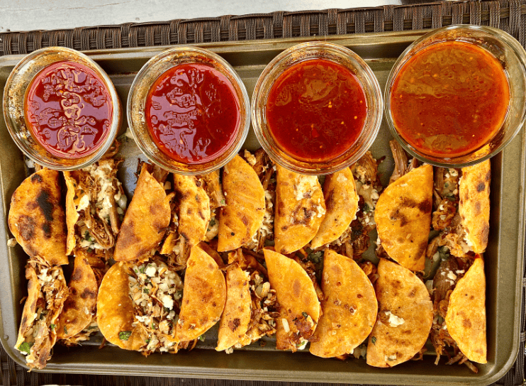 Birria Tacos Plate Gardenfrontier A plate of freshly griddled Birria tacos topped with cilantro