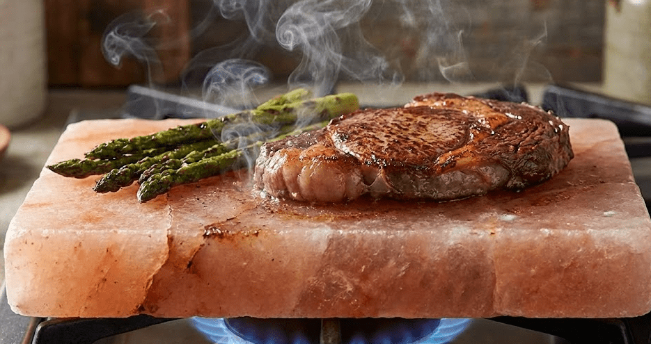 Cooking on Salt Block Gardenfrontier Himalayan salt block on gas burner with steak and asparagus