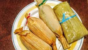 Chanchamitos Tamales Gardenfrontier A row of small round Chanchamito tamales tied at both ends with corn husks