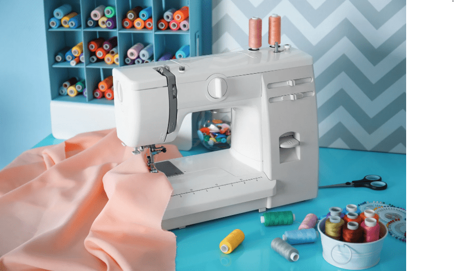 Beginner Sewing Machine Gardenfrontier Beginner friendly sewing machine with fabric thread scissors and sewing accessories on a table