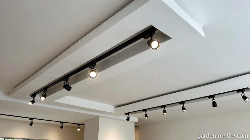A modern living room ceiling featuring a sleek recessed magnetic track light system with adjustable spotlights Gardenfrontier A modern living room ceiling featuring a sleek recessed magnetic track light system with adjustable spotlights