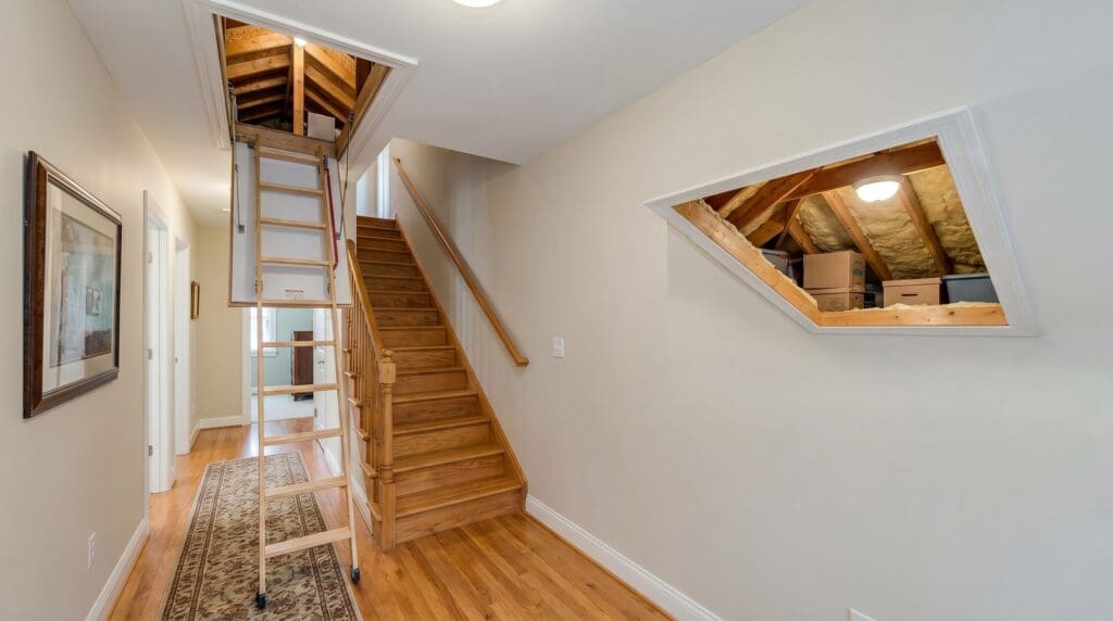 atticdoorsaccesspanels Gardenfrontier A white attic access door in a hallway ceiling with pull down attic stairs partially opened
